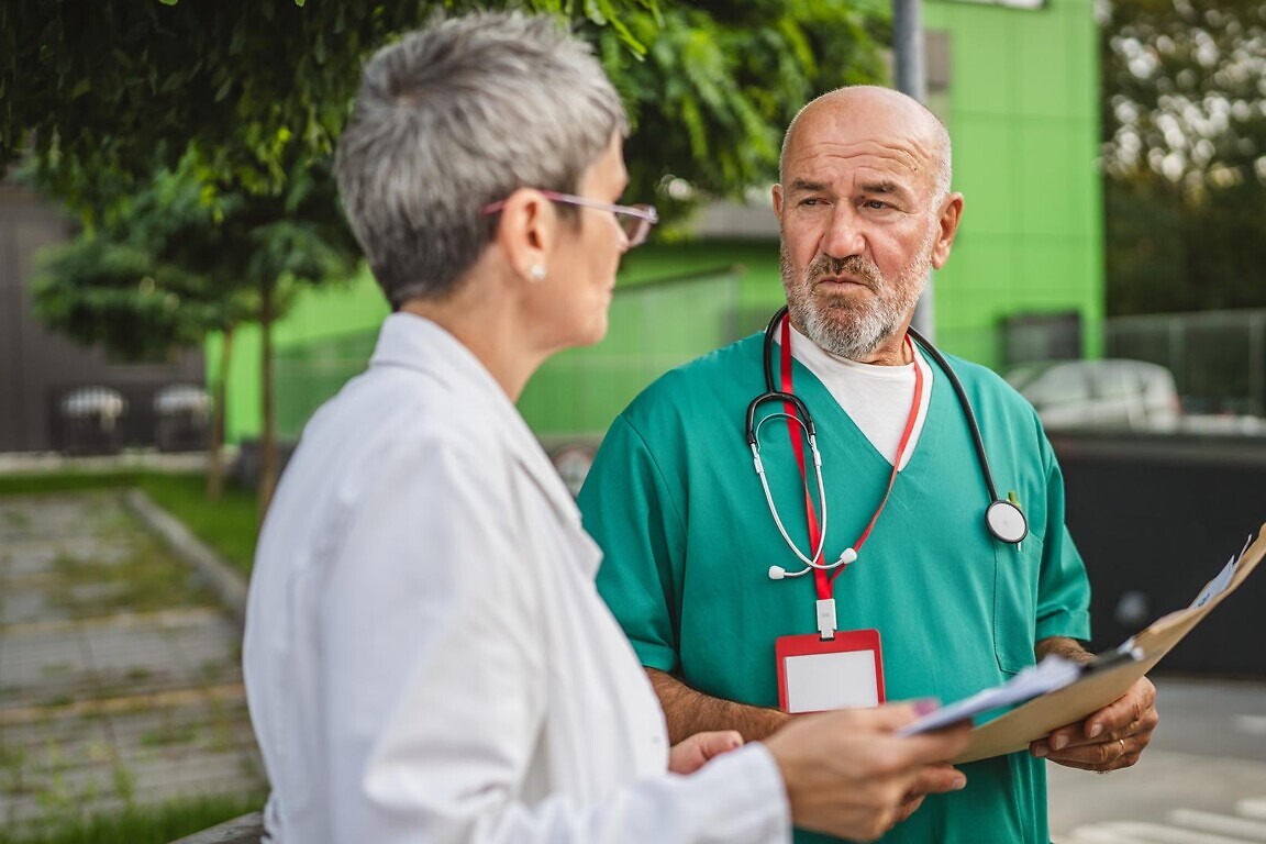 Two doctors colleagues discuss about patient results and look for a solution