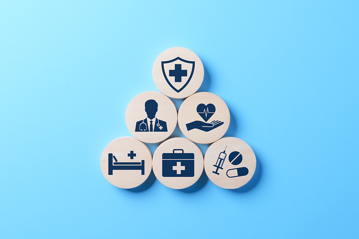 Health insurance and medical care concept. A set of wooden blocks displaying health-related icons, medical care, health insurance, and medication. healthcare services, protection, insurance coverage,