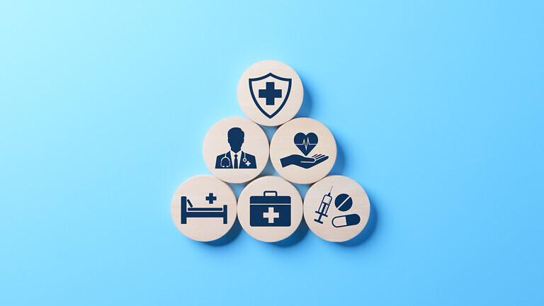 Health insurance and medical care concept. A set of wooden blocks displaying health-related icons, medical care, health insurance, and medication. healthcare services, protection, insurance coverage,