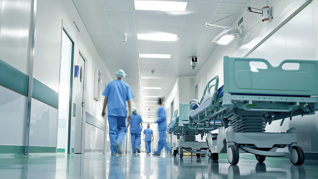 Blurred figures of people with medical uniforms in hospital.