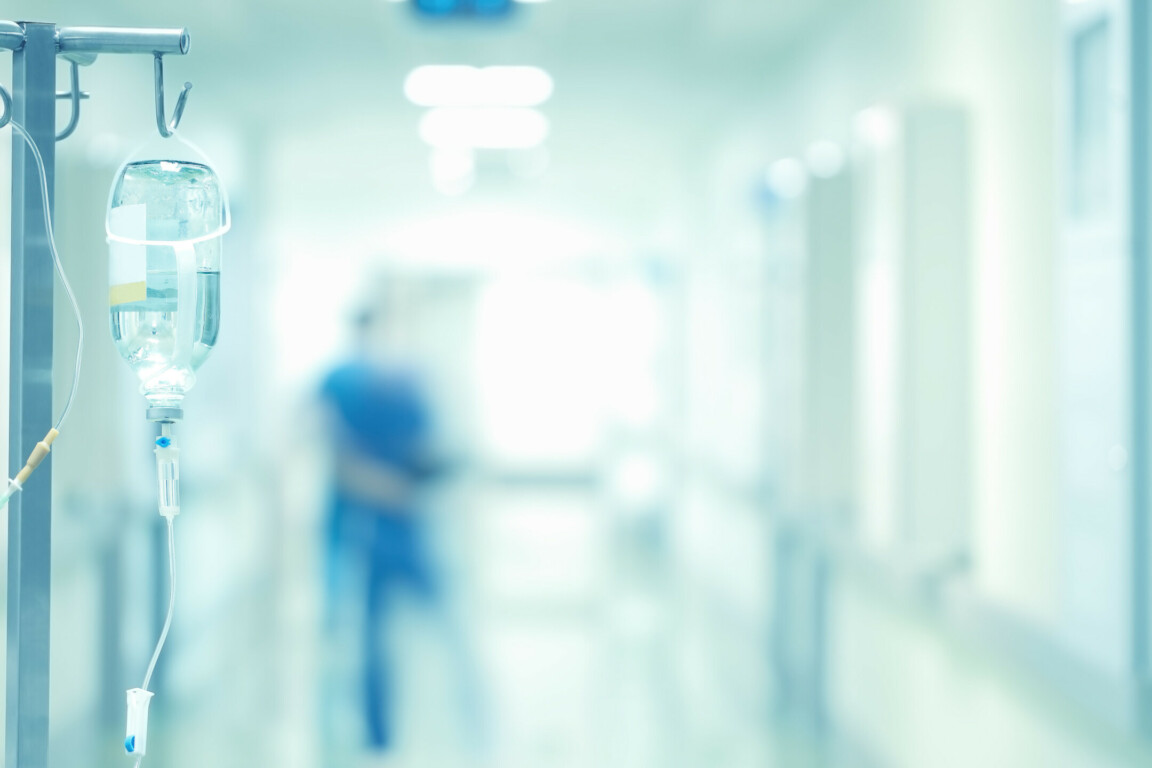 Medical drip in the blurred background of doctors.