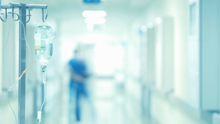 Medical drip in the blurred background of doctors.