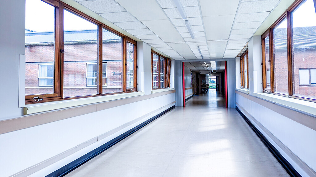 A Long Hospital Corridor Where Patients And Staff Transit