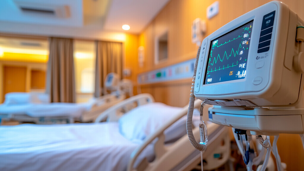 Modern hospital room with heart monitor and patient bed