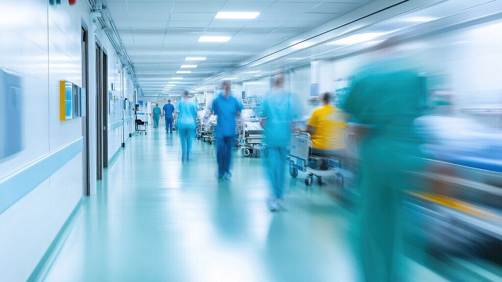 Busy hospital corridor with moving staff