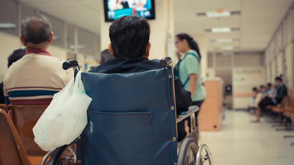 Patient elderly on wheelchair and many patient waiting a doctor and nurse in hospital , process in vintage style