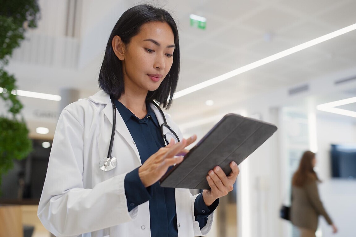 Portrait of a General Practitioner Using Tablet Co