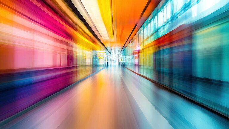 An abstract motion-blurred hospital corridor with a modern design and vibrant energy