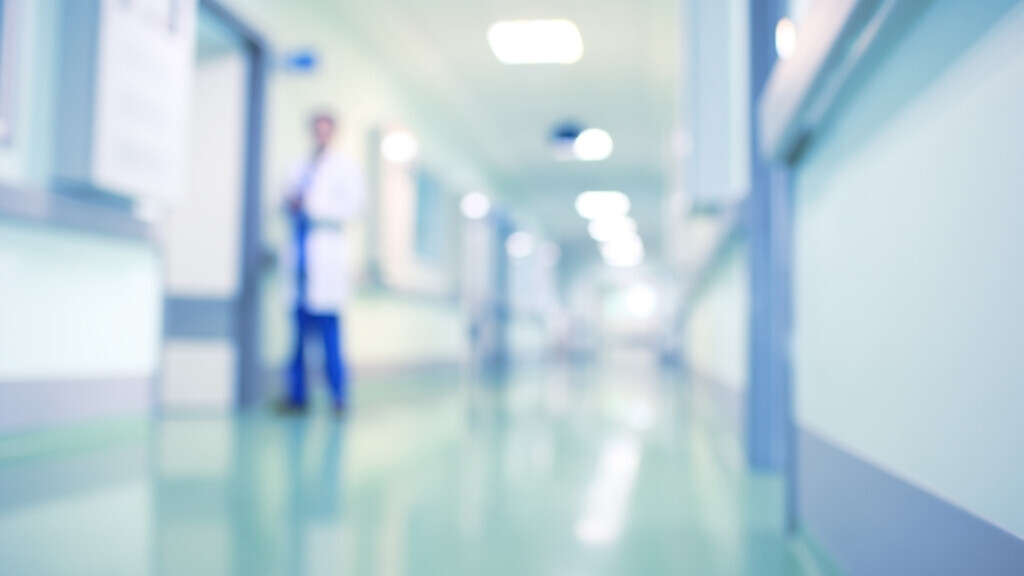 Doctor in hospital corridor, unfocused background