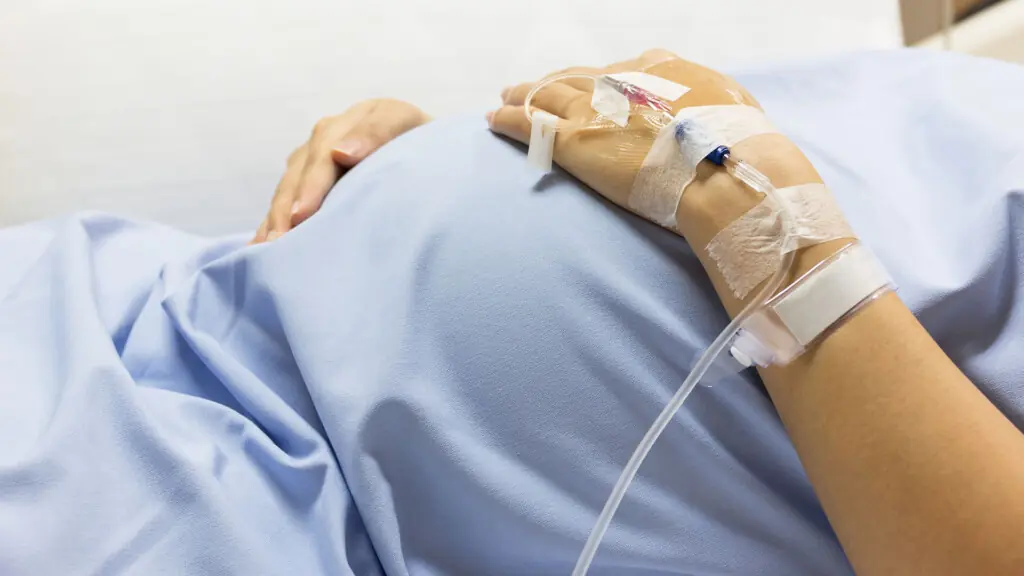 Close-up of a pregnant woman's belly in hospital