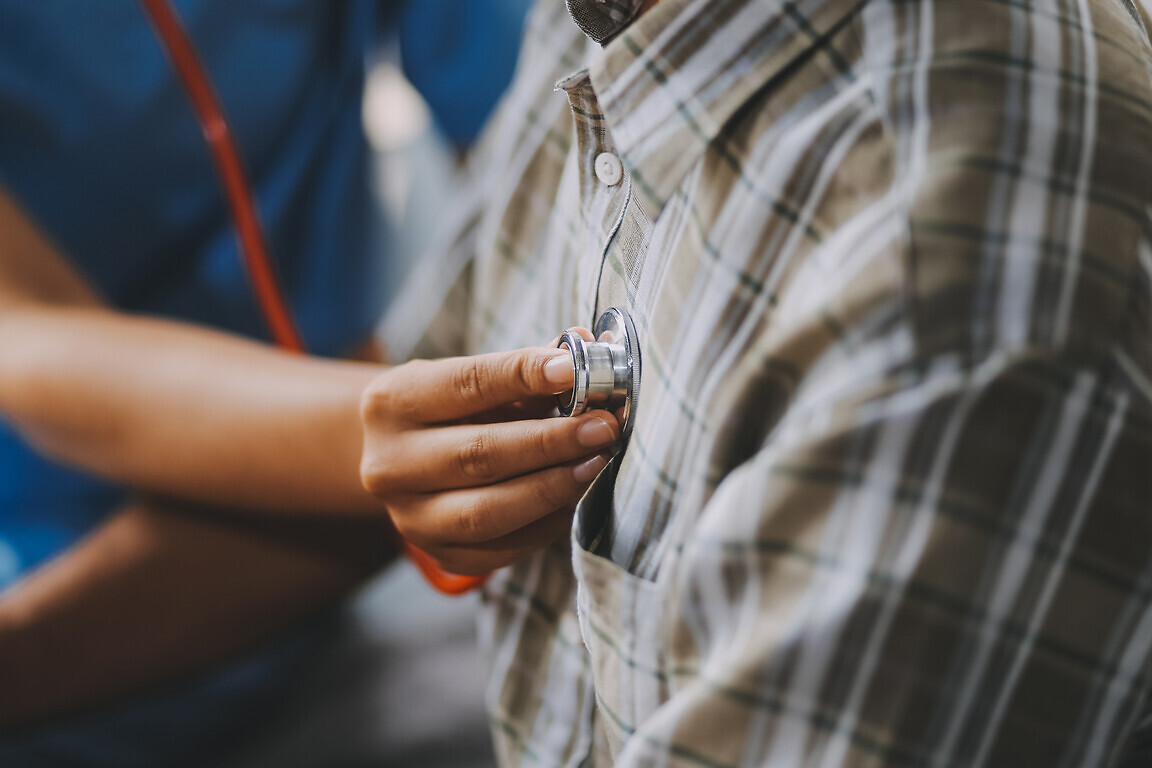Female doctor listening to heartbeat