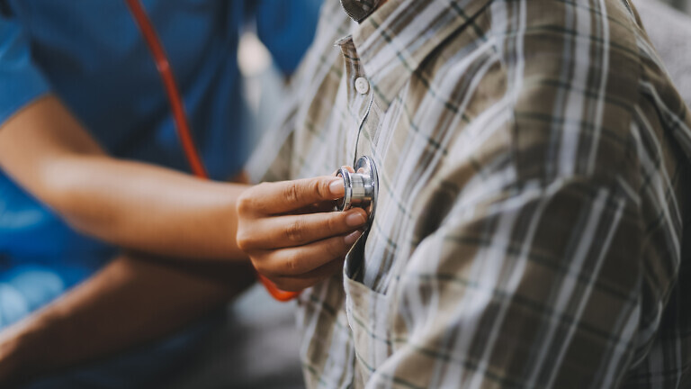 Female doctor listening to heartbeat