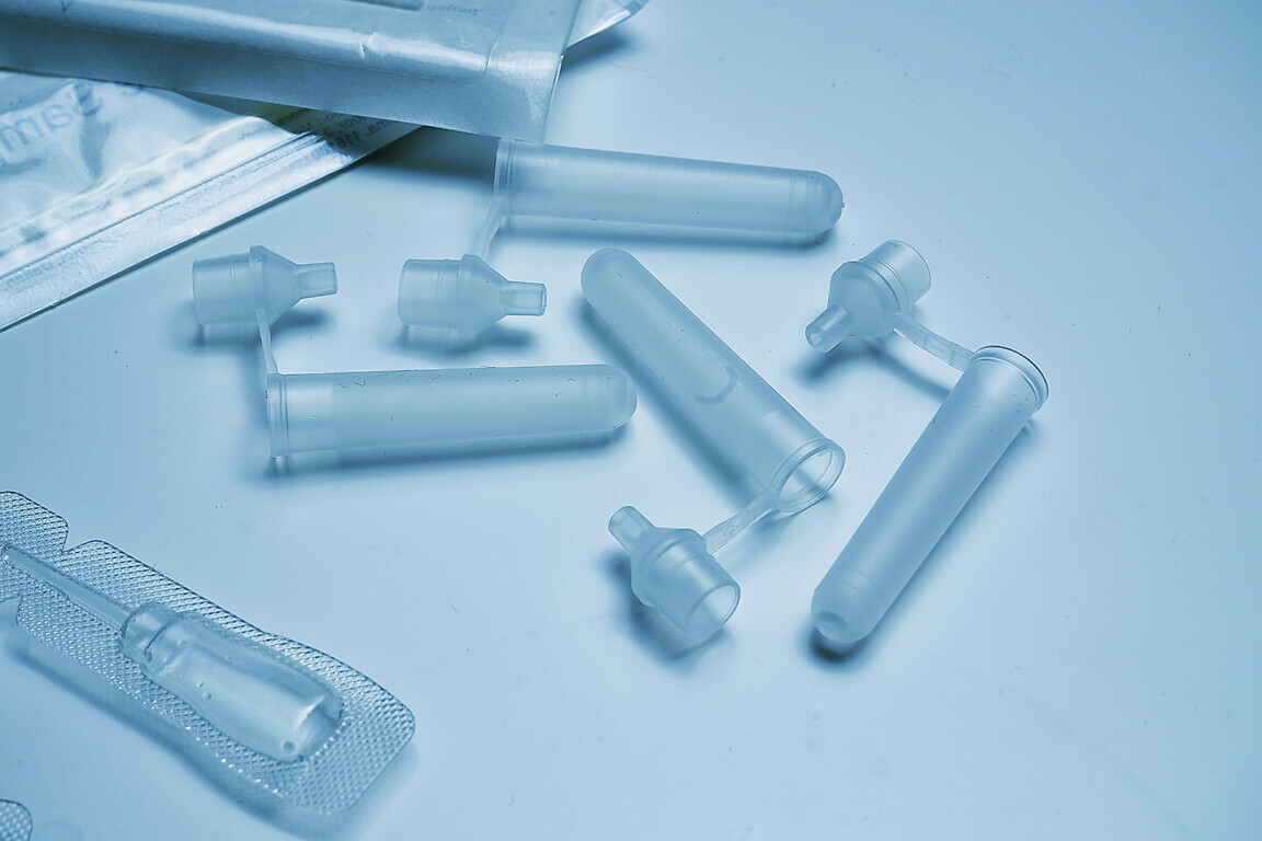 A collection of medical items including medications, virus test