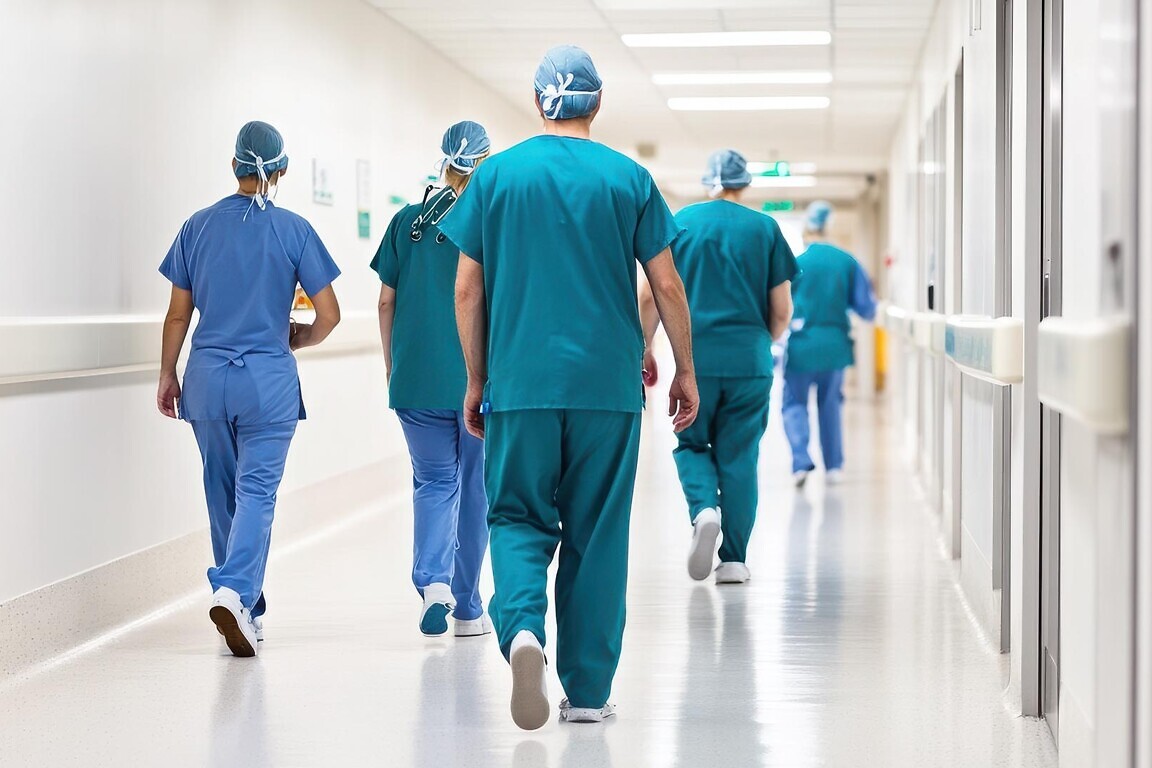 Healthcare professionals walking in hospital corridor, showcasin