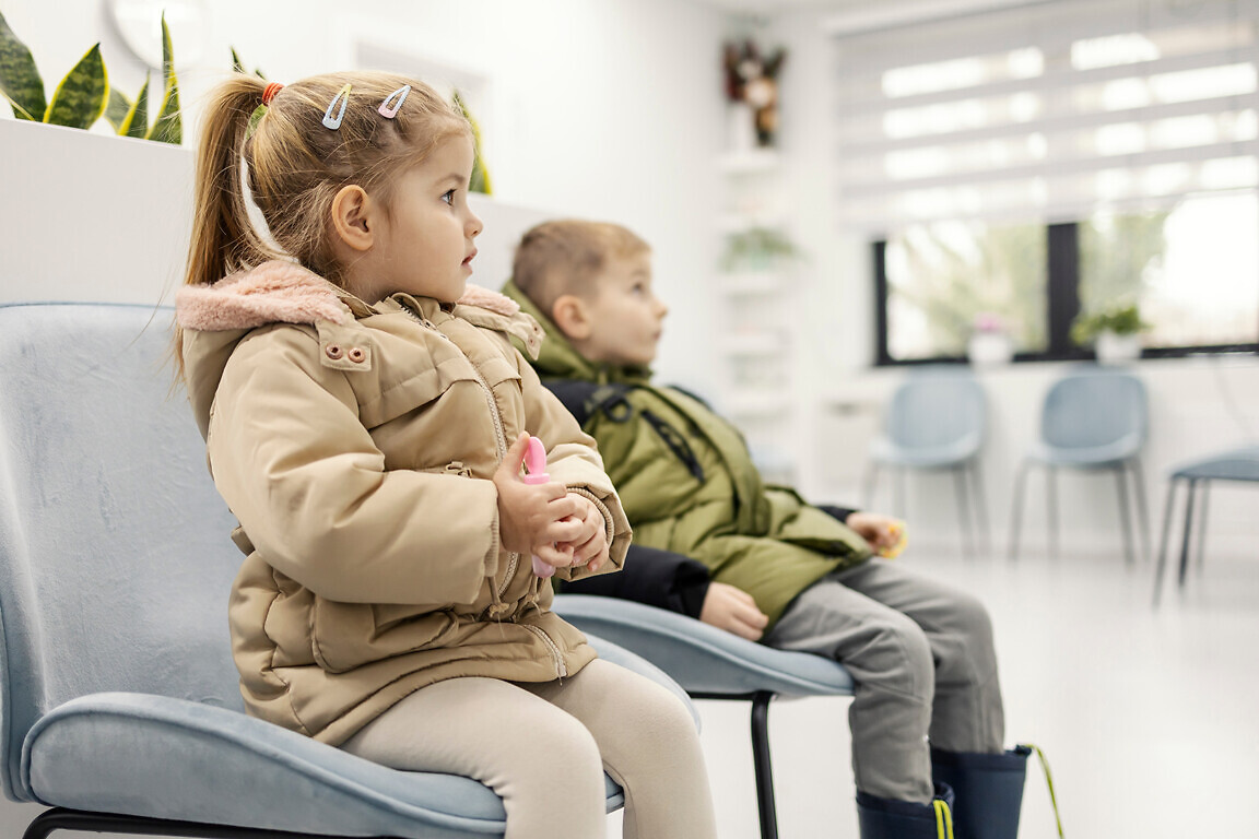 Children sitting in waiting room at hospital.