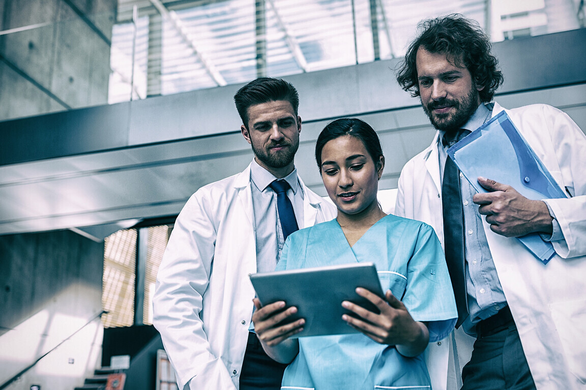Doctors and nurse looking at digital tablet