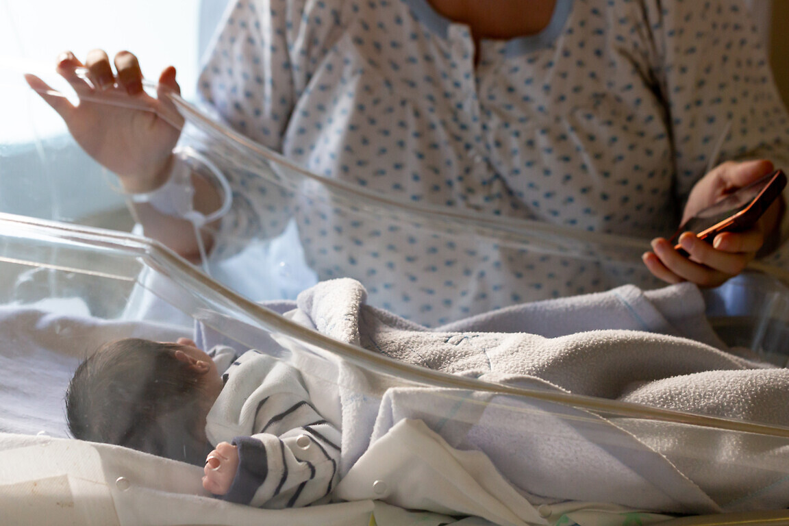 Mother checking on newborn baby