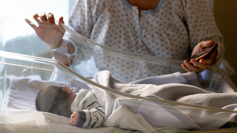 Mother checking on newborn baby