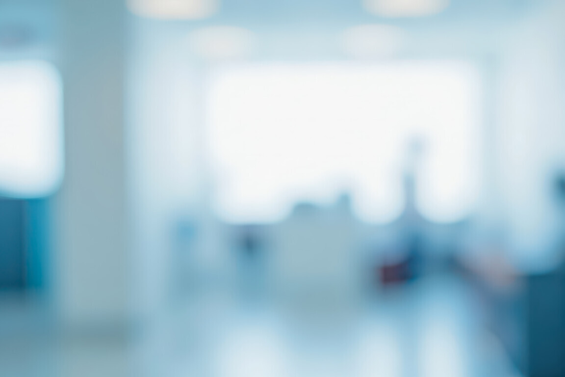 Bright out of focus hallway in corporate building or medical center, this clean blue backdrop is perfect for professional business websites and banners
