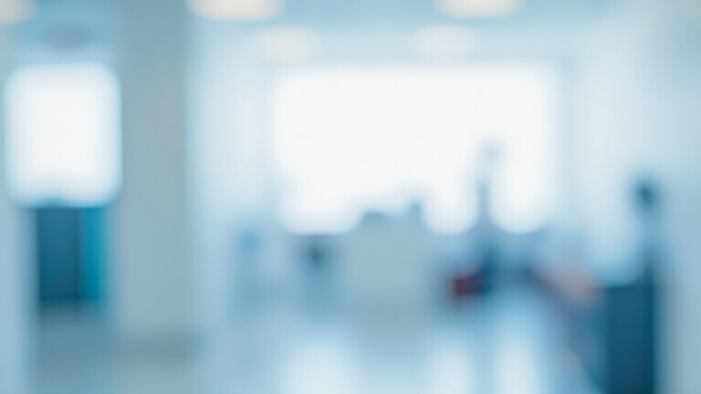 Bright out of focus hallway in corporate building or medical center, this clean blue backdrop is perfect for professional business websites and banners