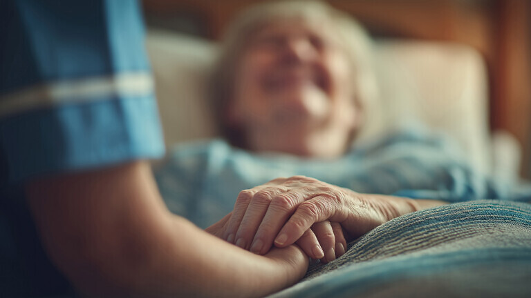 Smiling Nurse Holding Patient's Hand