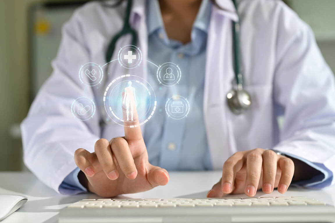 Doctor using virtual medical interface with digital icons for healthcare technology and patient data