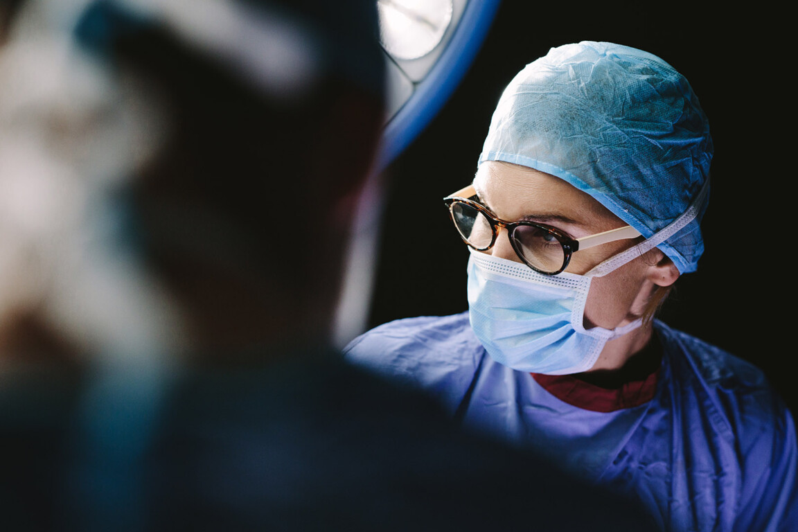 Female surgeon with team performing surgery