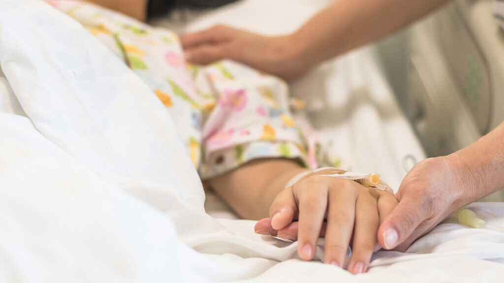 Nursing caretaker concept with kid patient sleeping in bed.