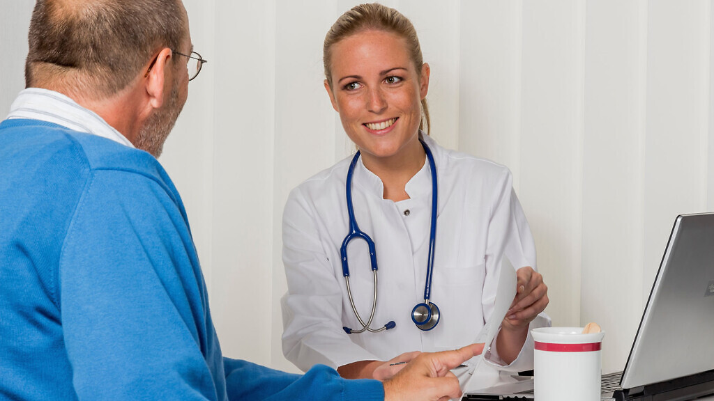 patient and doctor talking at the consultation in the doctor's office. trust in the family doctor.