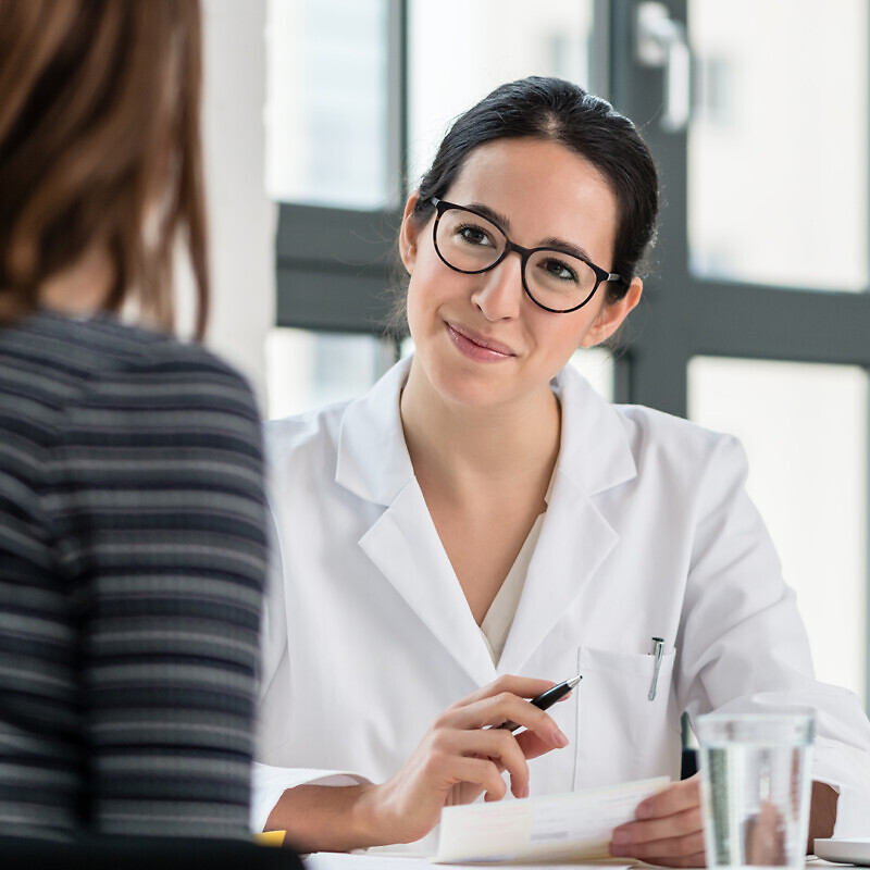 Female physician listening to her patient during consultation