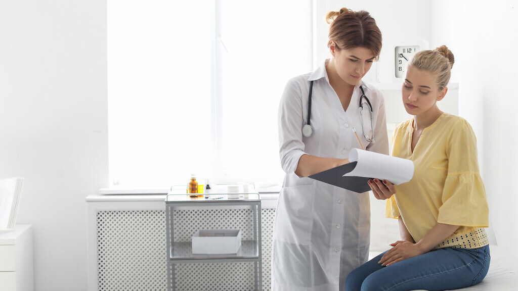 Patient having appointment with doctor in hospital