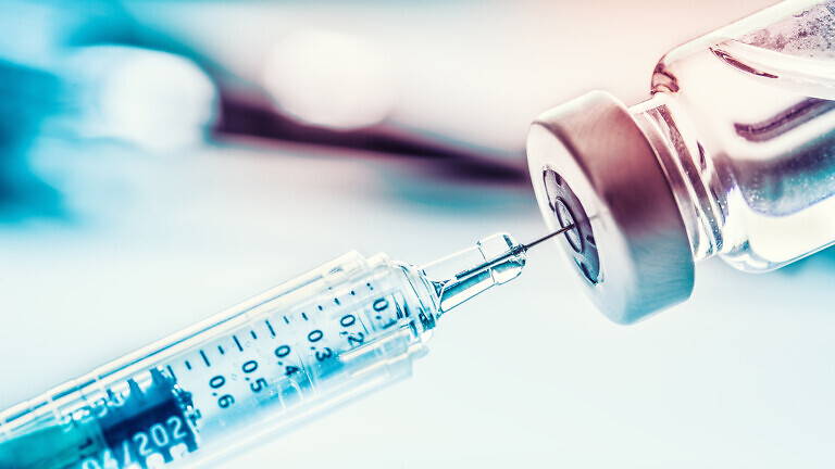 Close-up medical syringe with a vaccine.