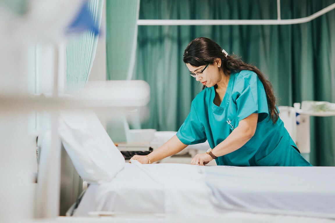 Nurse making the bed at a hospital