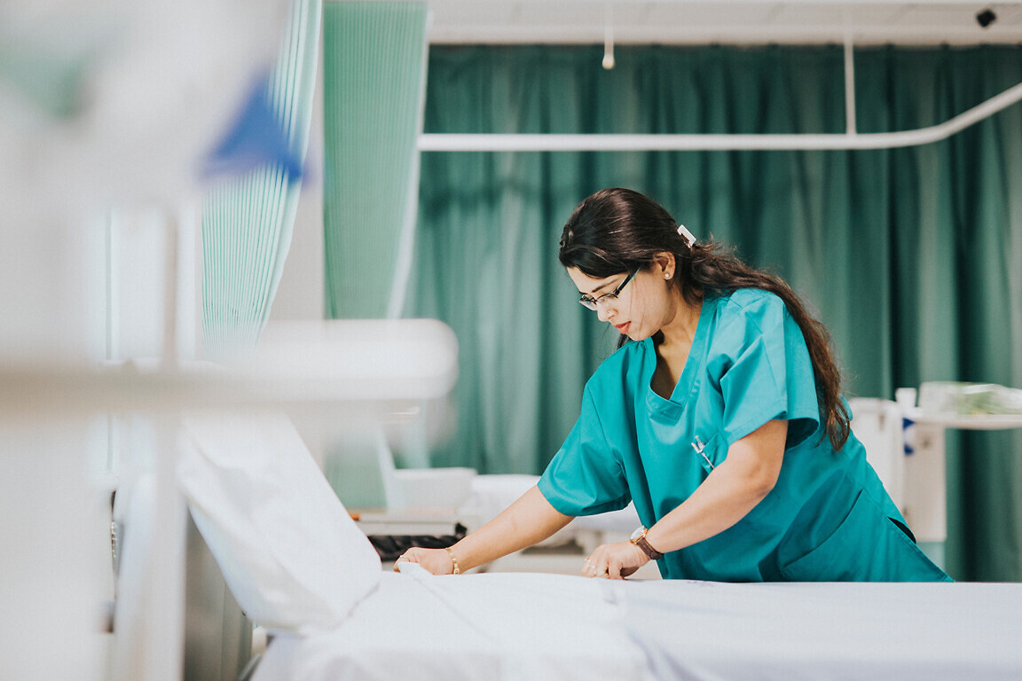 Nurse making the bed at a hospital