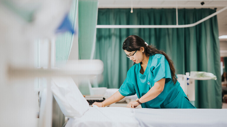 Nurse making the bed at a hospital
