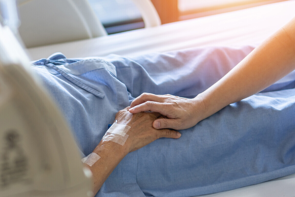 Caregiver holding elderly senior patient.
