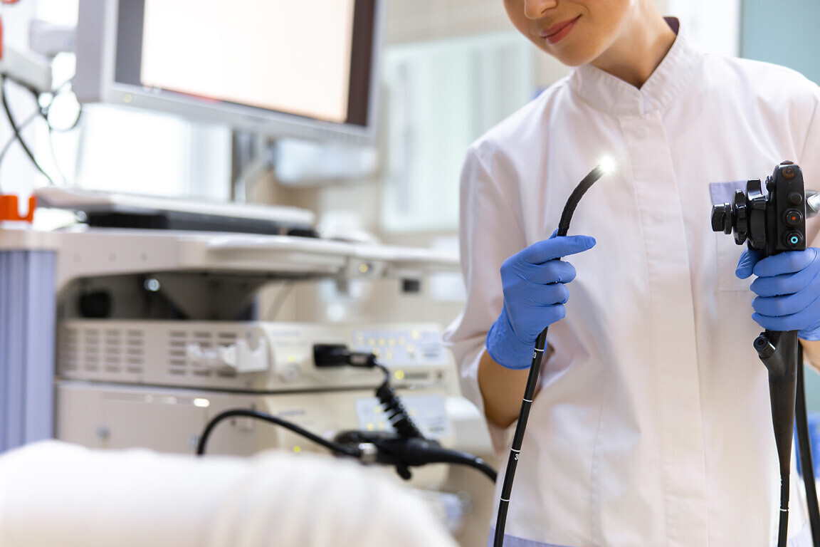 Doctor doing endoscopy examination in office.