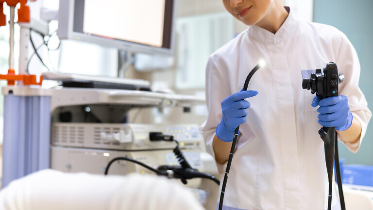 Doctor doing endoscopy examination in office.