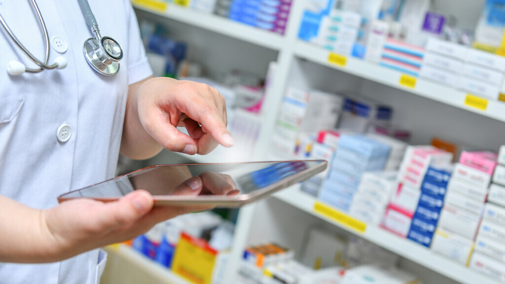 Doctor using computer tablet for search bar on display in pharma