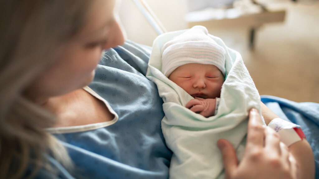 A Mother with her newborn baby at the hospital a day after a natural birth labour.