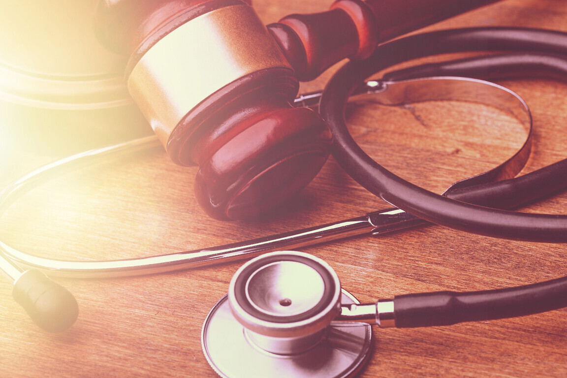 Judge wooden gavel and medical stethoscope