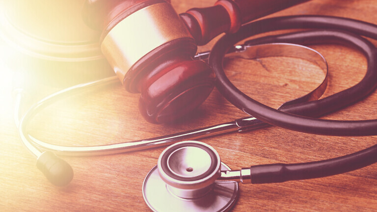 Judge wooden gavel and medical stethoscope