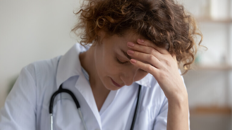 Unhappy female doctor feel stressed at workplace
