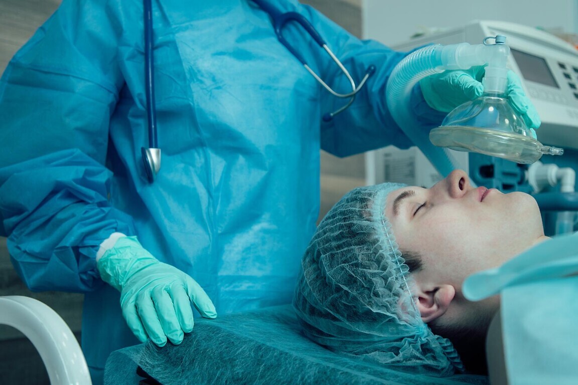 Medical worker giving general anesthesia to the patient