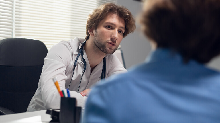 Healthcare and medicine concept - a doctor with his patient in a consultation room