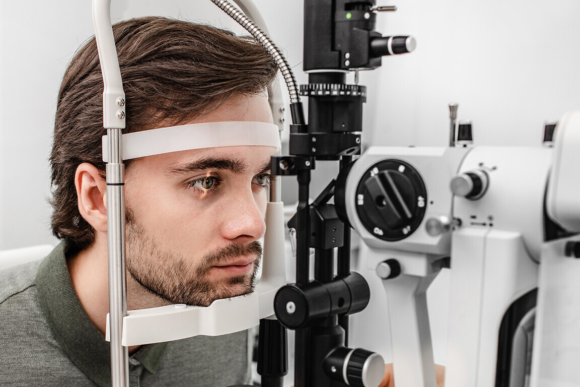 Adult man getting an eye exam at ophthalmology clinic.