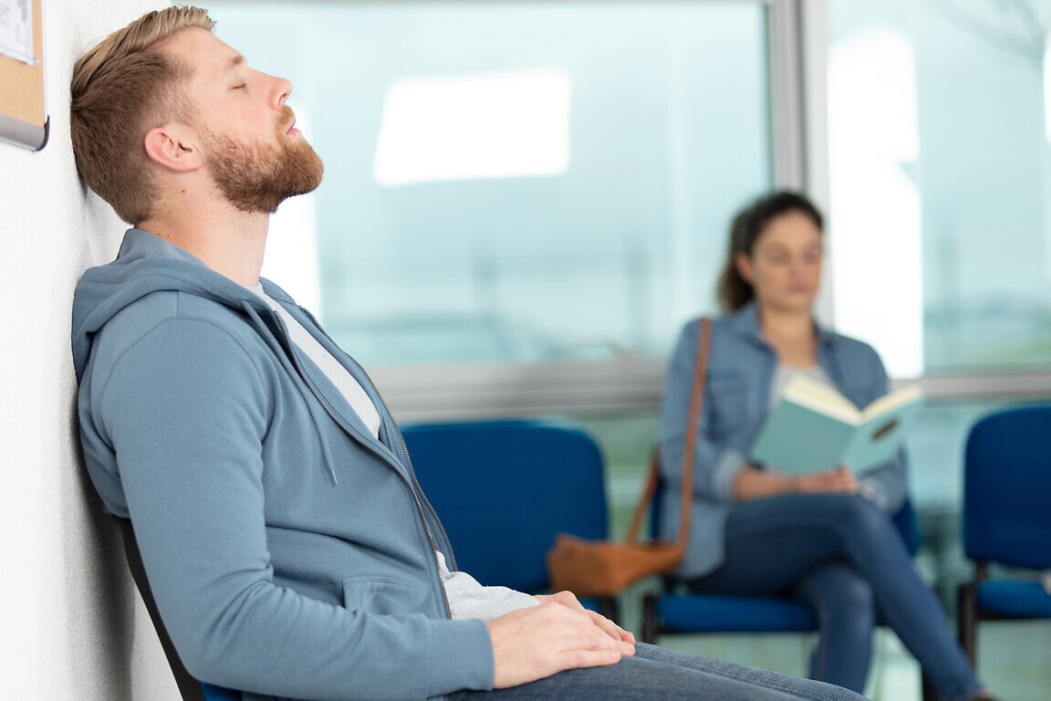 man sitting in doctors waiting room