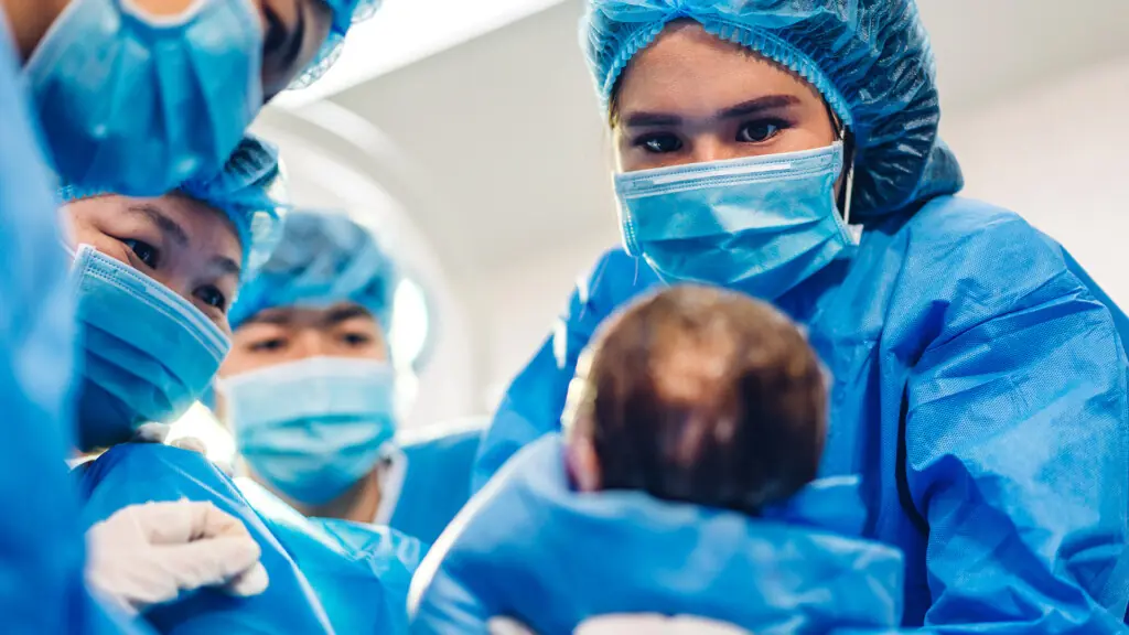 Midwife Holding Infant Baby. 