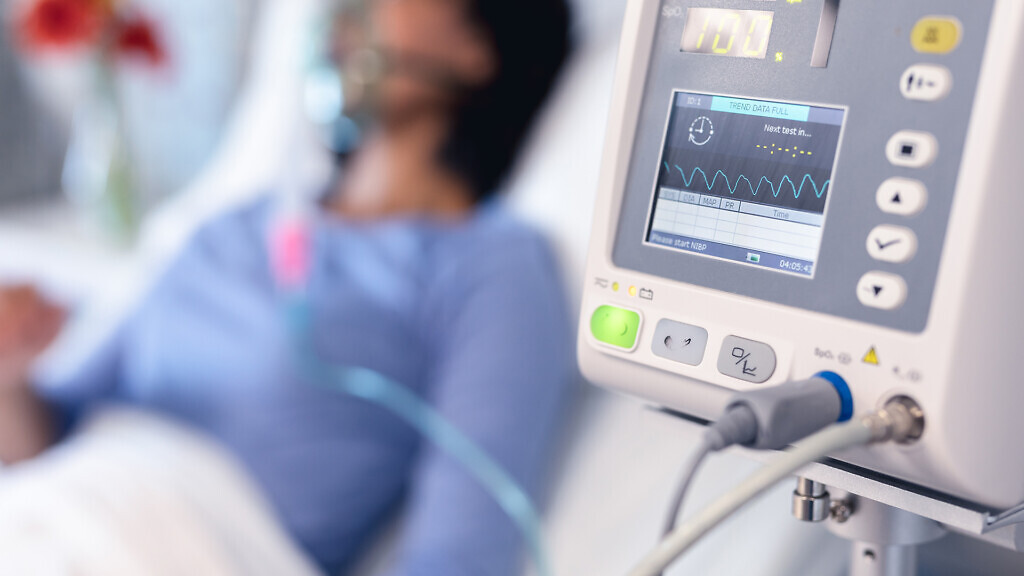 Ventilator monitor and african american female patient in hospital