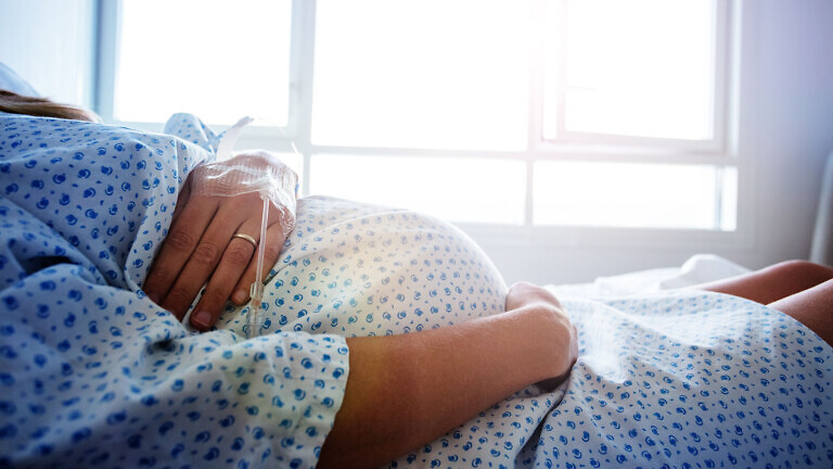 Close-up of a pregnant woman's belly in hospital